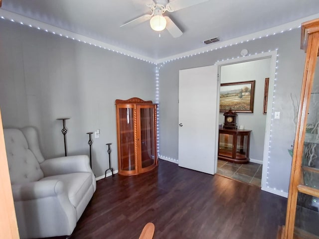 sitting room featuring ceiling fan and dark hardwood / wood-style flooring