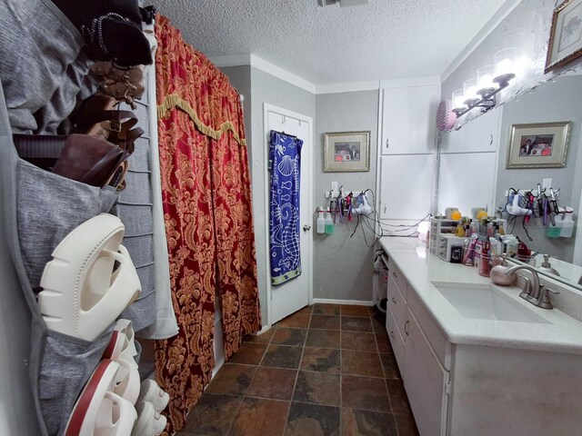 bathroom with vanity and a textured ceiling