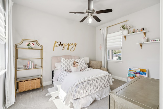 bedroom with ceiling fan, baseboards, and carpet floors