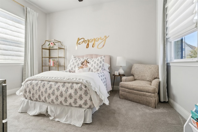 bedroom with baseboards and carpet