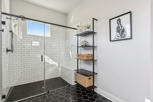 full bathroom featuring a stall shower and baseboards