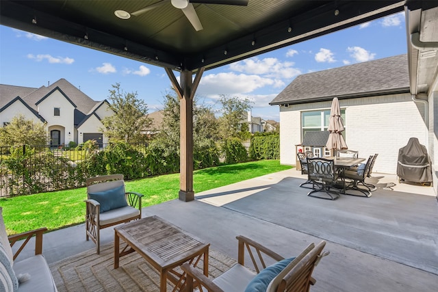 view of patio / terrace with outdoor dining space, a ceiling fan, fence, and an outdoor hangout area