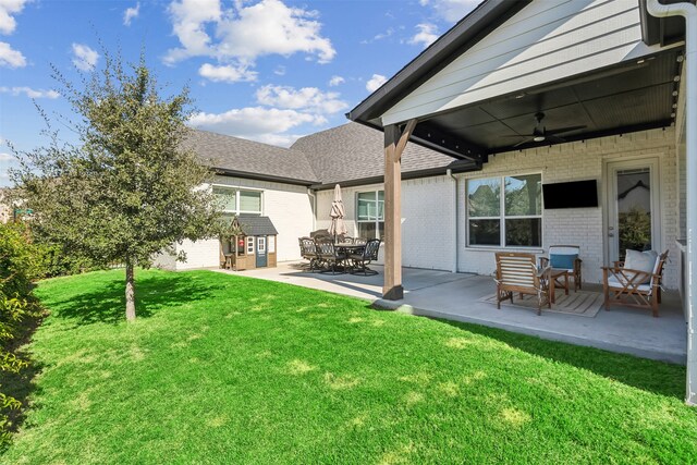 view of yard with ceiling fan and a patio area