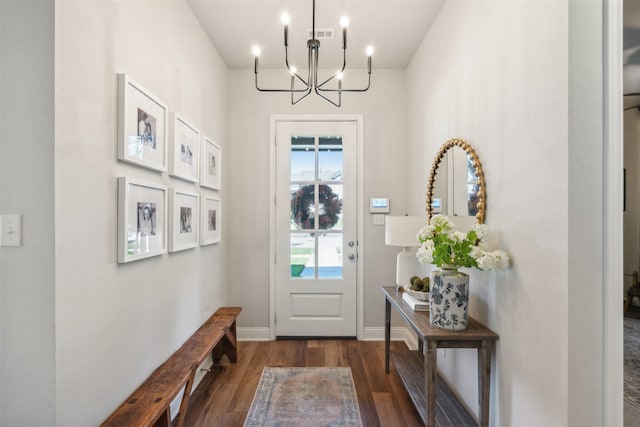 doorway to outside with an inviting chandelier, baseboards, and wood finished floors