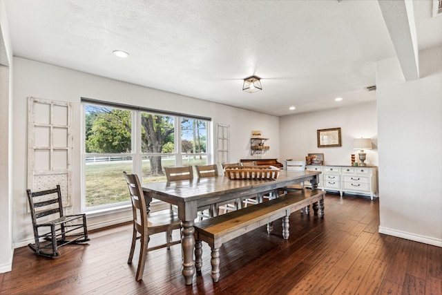 dining area featuring a textured ceiling, recessed lighting, dark wood-style flooring, visible vents, and baseboards