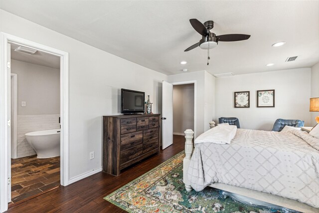 bedroom featuring ceiling fan, dark wood-type flooring, tile walls, and ensuite bath