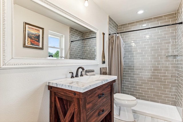 bathroom featuring vanity, toilet, and walk in shower