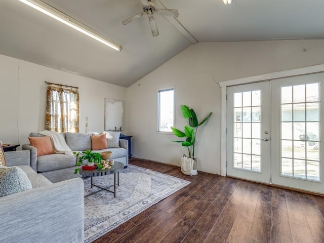 living room with lofted ceiling with beams, dark wood-type flooring, ceiling fan, and french doors