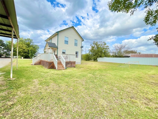 back of house featuring a yard and a deck