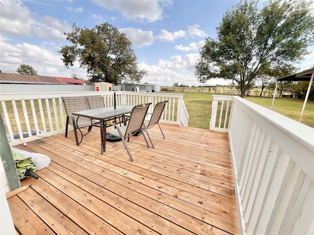 wooden terrace with a lawn