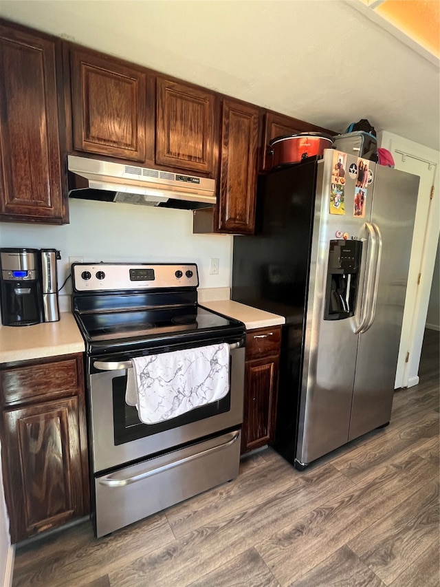 kitchen with hardwood / wood-style floors, appliances with stainless steel finishes, and dark brown cabinets