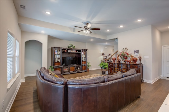 living room with dark wood-type flooring and ceiling fan