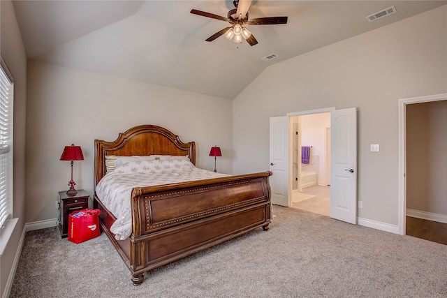 carpeted bedroom with ceiling fan, multiple windows, lofted ceiling, and ensuite bathroom