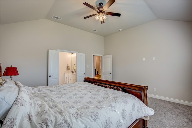 carpeted bedroom featuring lofted ceiling, ensuite bathroom, and ceiling fan