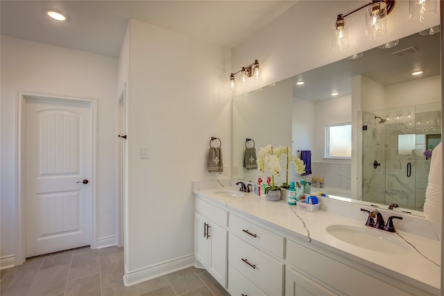 bathroom featuring vanity, a shower with shower door, and tile patterned flooring