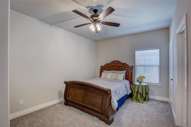 bedroom with ceiling fan and light carpet