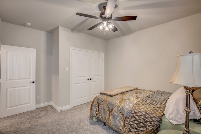 carpeted bedroom with a closet and ceiling fan