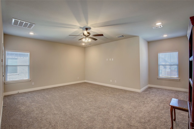 carpeted empty room featuring ceiling fan