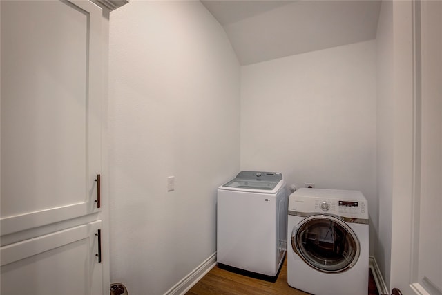 clothes washing area with hardwood / wood-style flooring and washer and clothes dryer