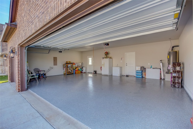 garage with gas water heater and white fridge