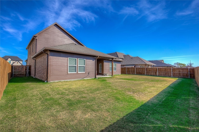 rear view of house with a lawn