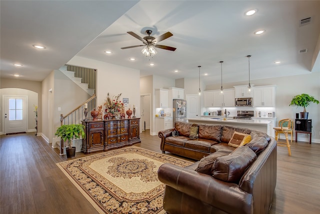 living room with ceiling fan, wood-type flooring, and sink