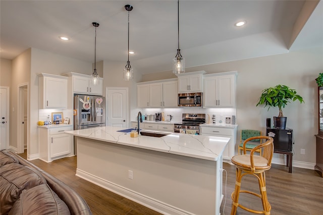 kitchen with white cabinetry, stainless steel appliances, decorative light fixtures, and dark hardwood / wood-style flooring