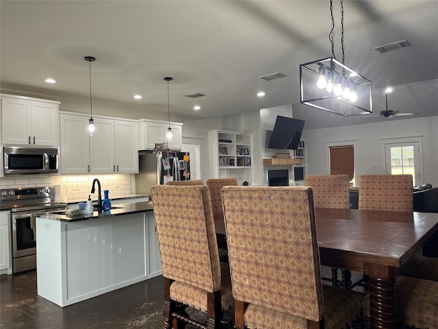 dining room featuring sink and ceiling fan