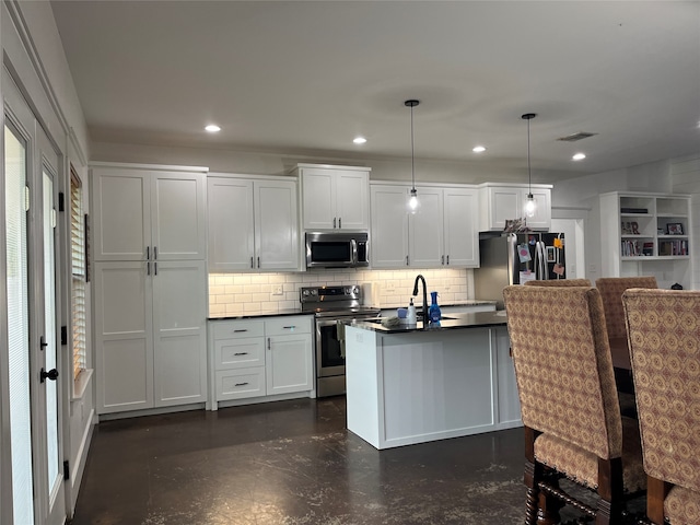 kitchen featuring appliances with stainless steel finishes, a kitchen island, backsplash, hanging light fixtures, and white cabinetry