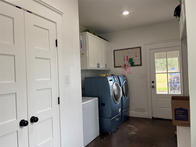 laundry area featuring washer and dryer and cabinets