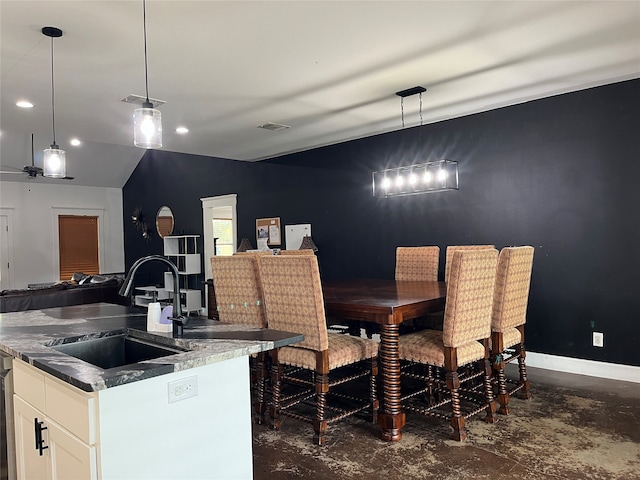 dining area with lofted ceiling and sink