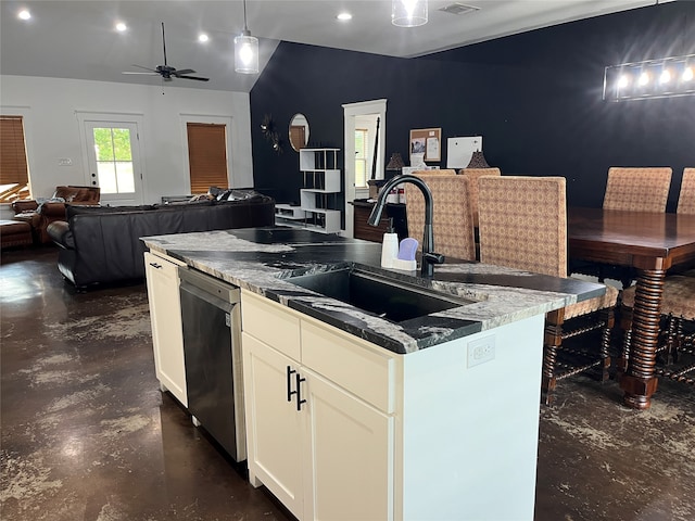 kitchen with a kitchen island with sink, sink, pendant lighting, stainless steel dishwasher, and white cabinets