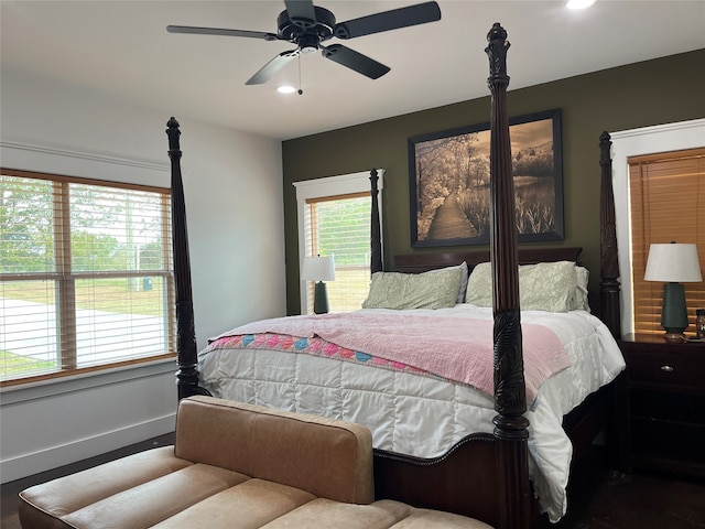 bedroom featuring multiple windows, wood-type flooring, and ceiling fan