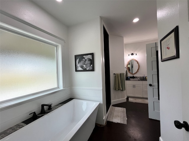 bathroom featuring vanity and a washtub