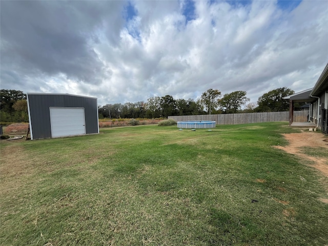 view of yard with an outbuilding and a garage