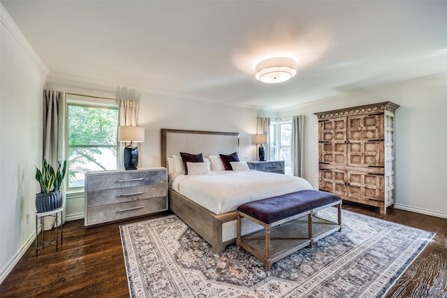 bedroom with crown molding and dark hardwood / wood-style flooring