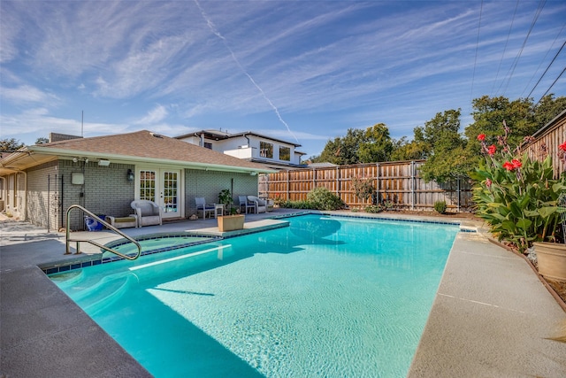 view of swimming pool featuring a patio area and french doors