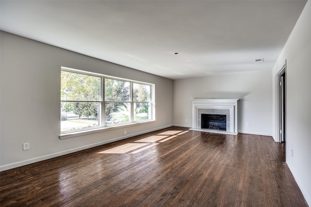 unfurnished living room with a premium fireplace and dark hardwood / wood-style flooring