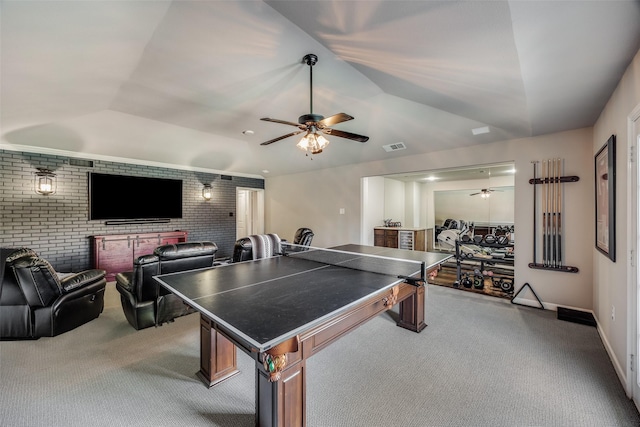 rec room featuring lofted ceiling, ceiling fan, carpet floors, and brick wall