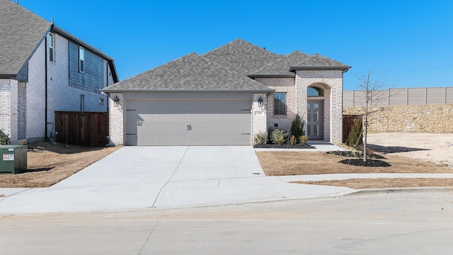 view of front of property with a garage and central AC