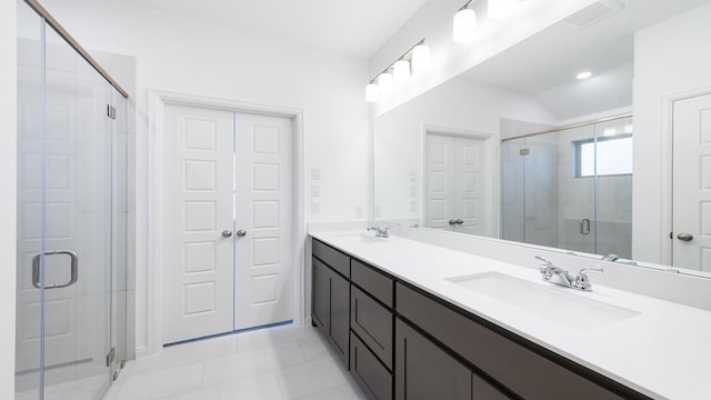 bathroom featuring vanity, an enclosed shower, and tile patterned floors