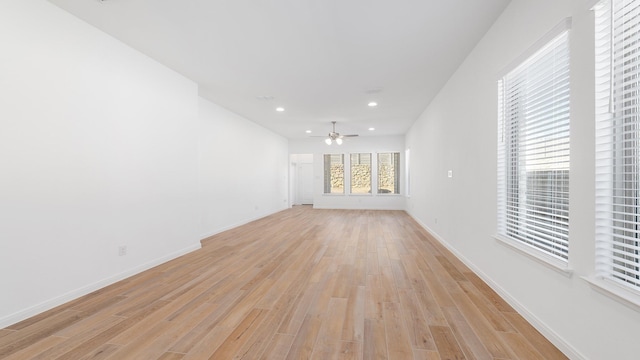 unfurnished living room with ceiling fan and light hardwood / wood-style flooring