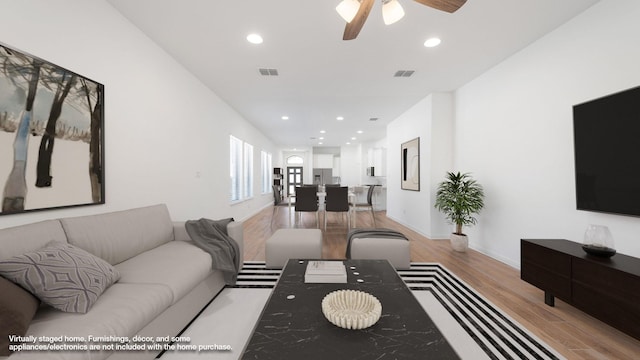 living room featuring ceiling fan and light wood-type flooring