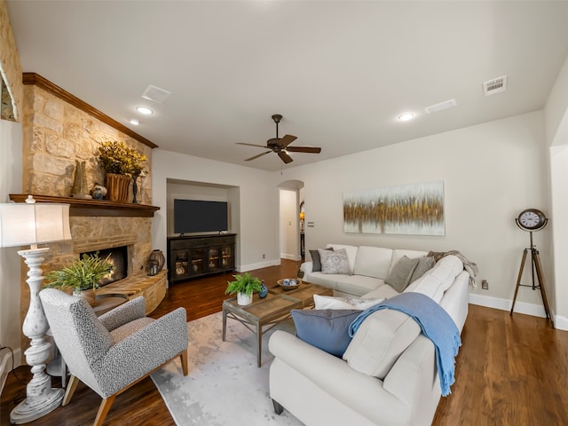 living room with ceiling fan, a fireplace, and hardwood / wood-style floors