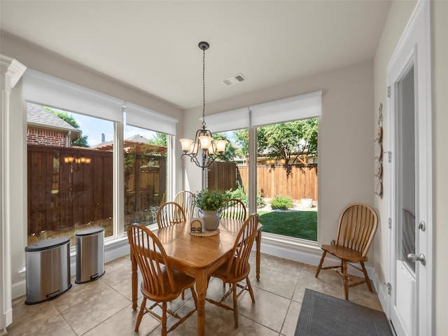 dining area featuring light tile patterned floors and a chandelier