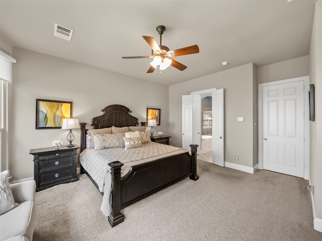 bedroom featuring ceiling fan, connected bathroom, and light carpet