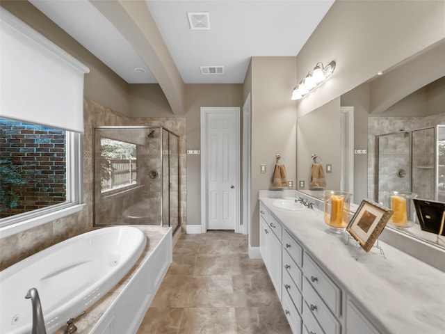 bathroom featuring plus walk in shower and vanity