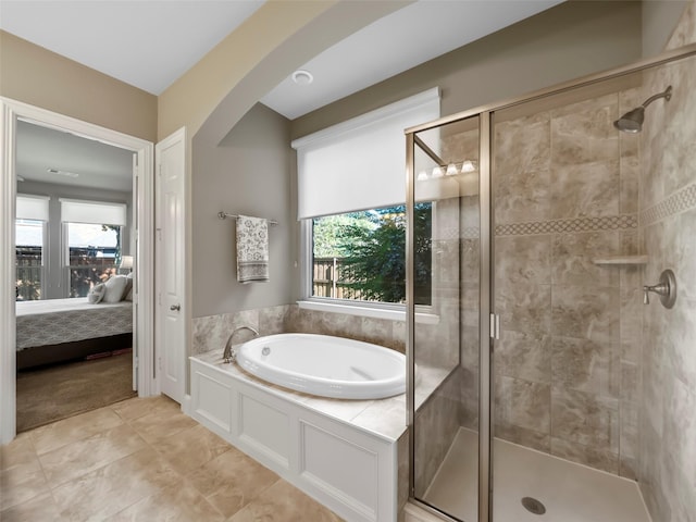 bathroom featuring a wealth of natural light, tile patterned floors, and shower with separate bathtub