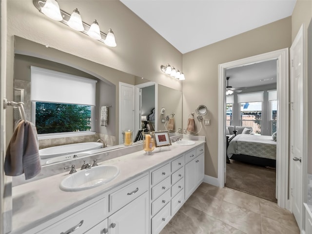 bathroom with ceiling fan, tile patterned floors, vanity, and a tub