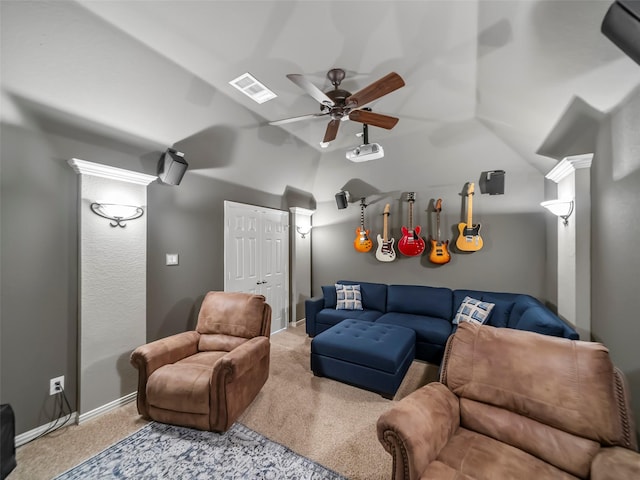 carpeted home theater room with vaulted ceiling and ceiling fan